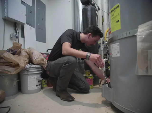 Technician servicing the controls on a water heater